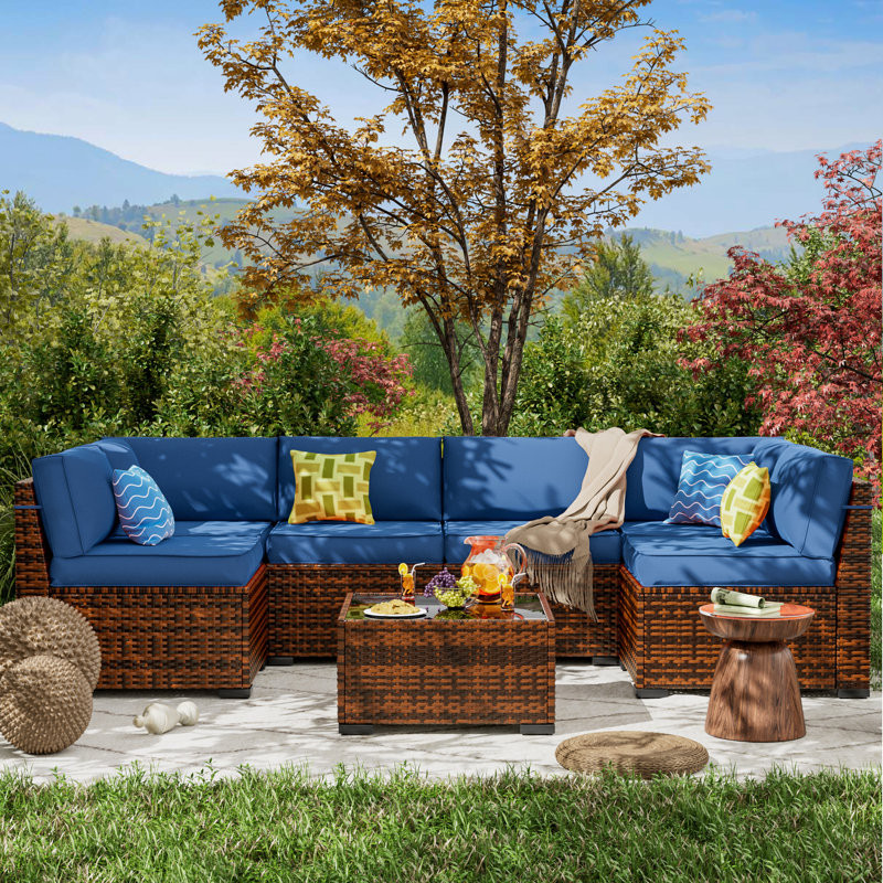 Mecayla 7 Piece Rattan Sectional Seating Group with Cushions